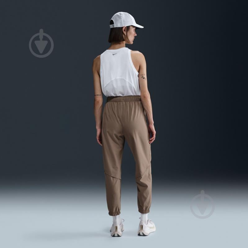 Штани Nike W NK FAST DF WRM MR 7/8 PNT FB7730-214 р. L коричневий - фото 7
