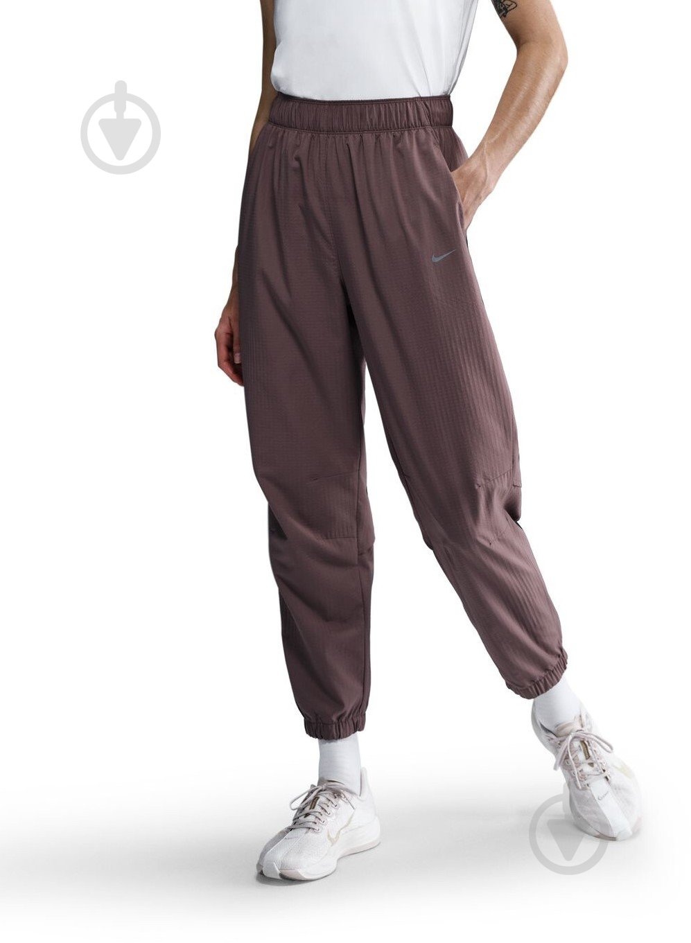 Штани Nike W NK FAST DF WRM MR 7/8 PNT FB7730-214 р. XS коричневий - фото 1