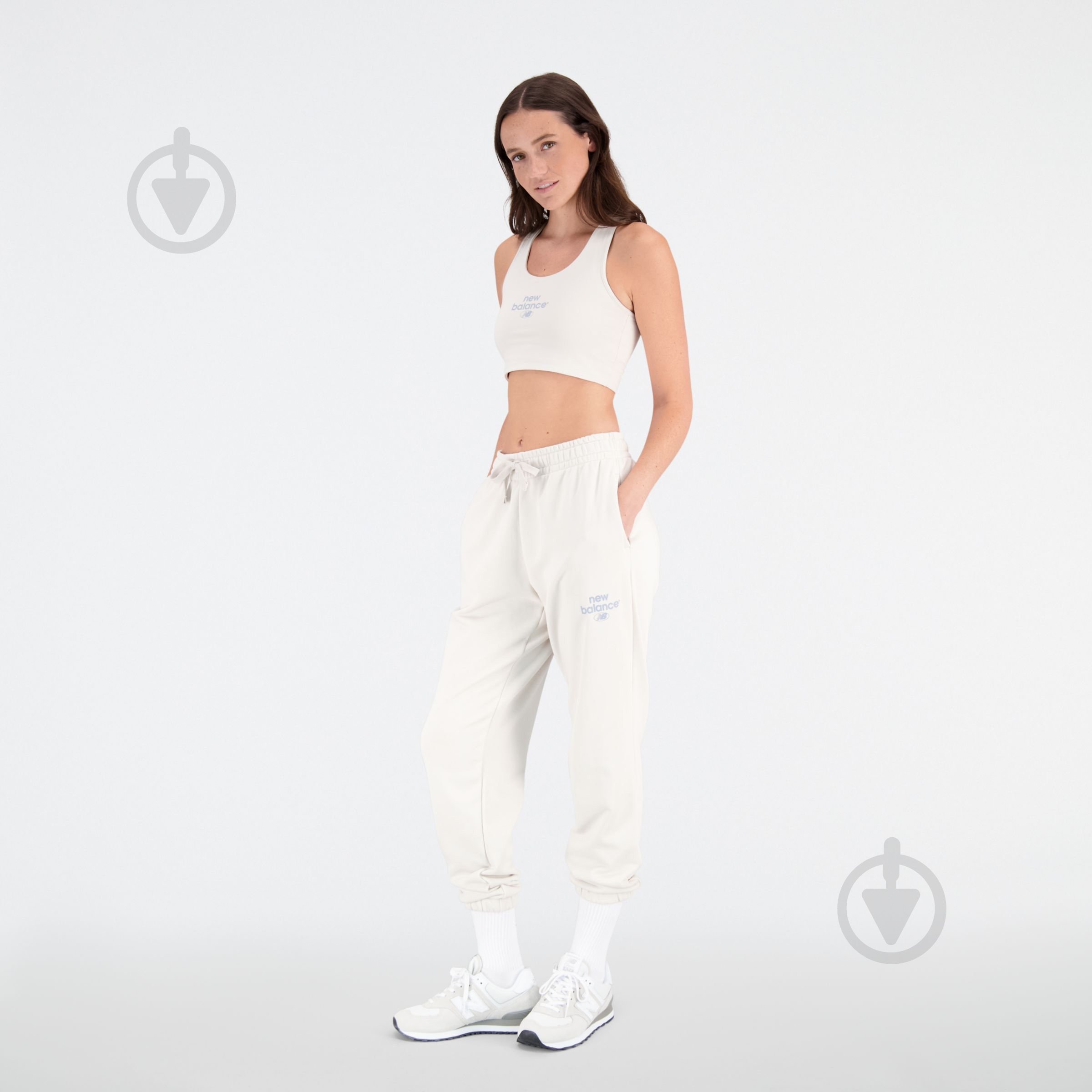 Штани New Balance ESSENTIALS REIMAGINED ARCH WP31508MBM р. L бежевий - фото 1