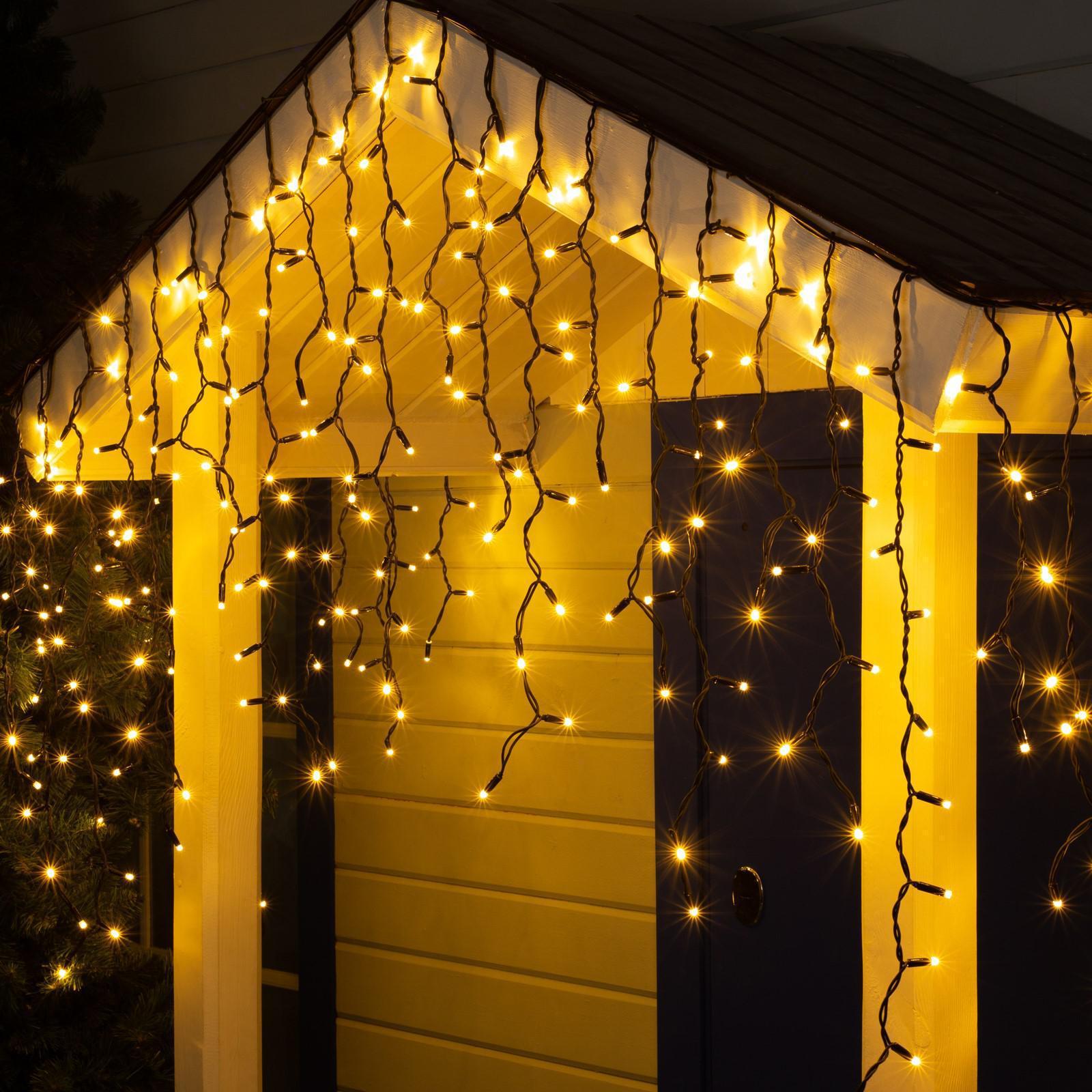 Гірлянда вулична світлодіодна Бахрома 5х0,7 м 100 LED з перехідником/чорний дріт/від мережі Теплий білий (5564637)