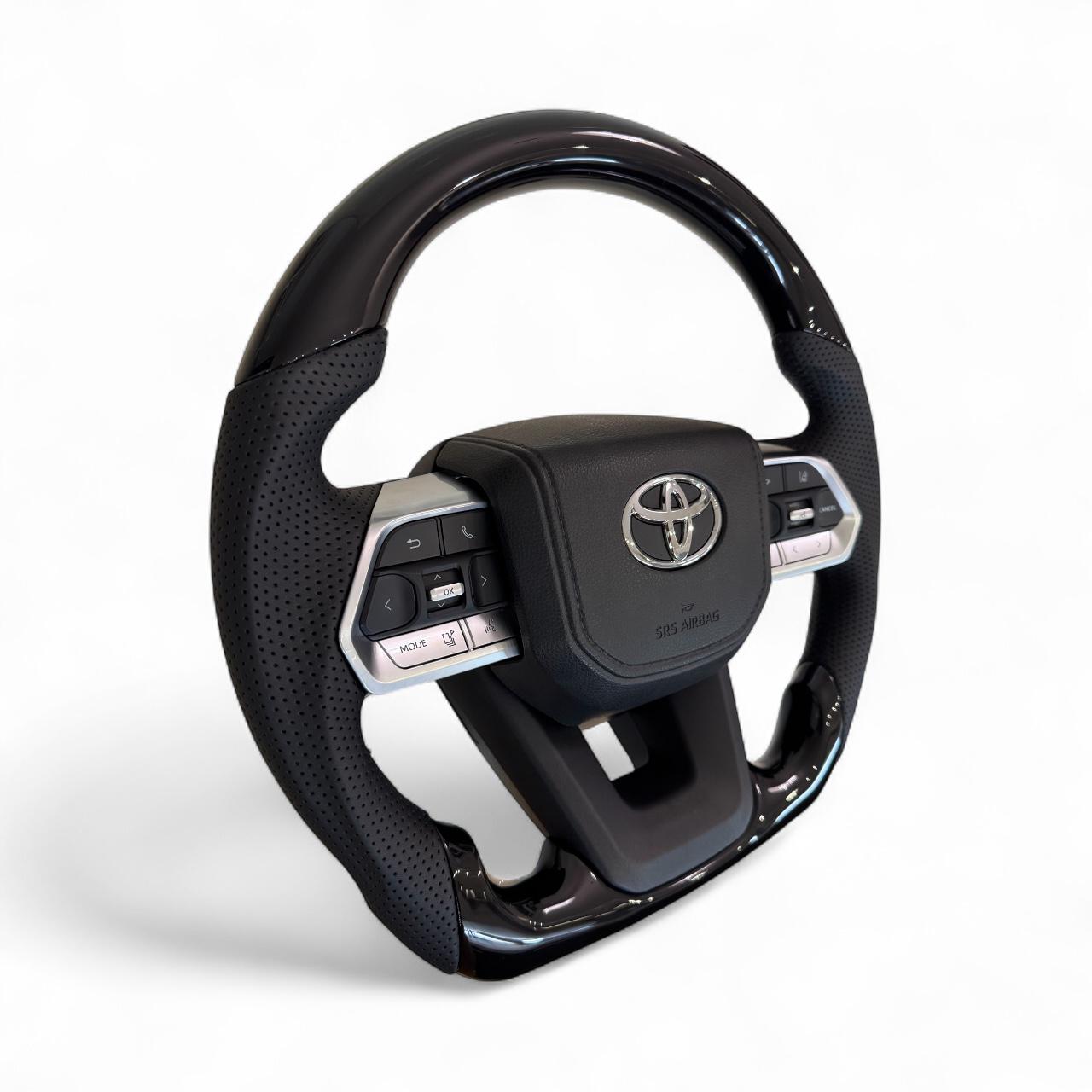 Руль для Toyota Land Cruiser 100/Prado 120 рояльный лак со скошенным низом логотип и кнопки хром (29014242) - фото 4 Руль для Toyota Land Cruiser 100/Prado 120 рояльный лак со скошенным низом логотип и кнопки хром (29014242) - фото 4