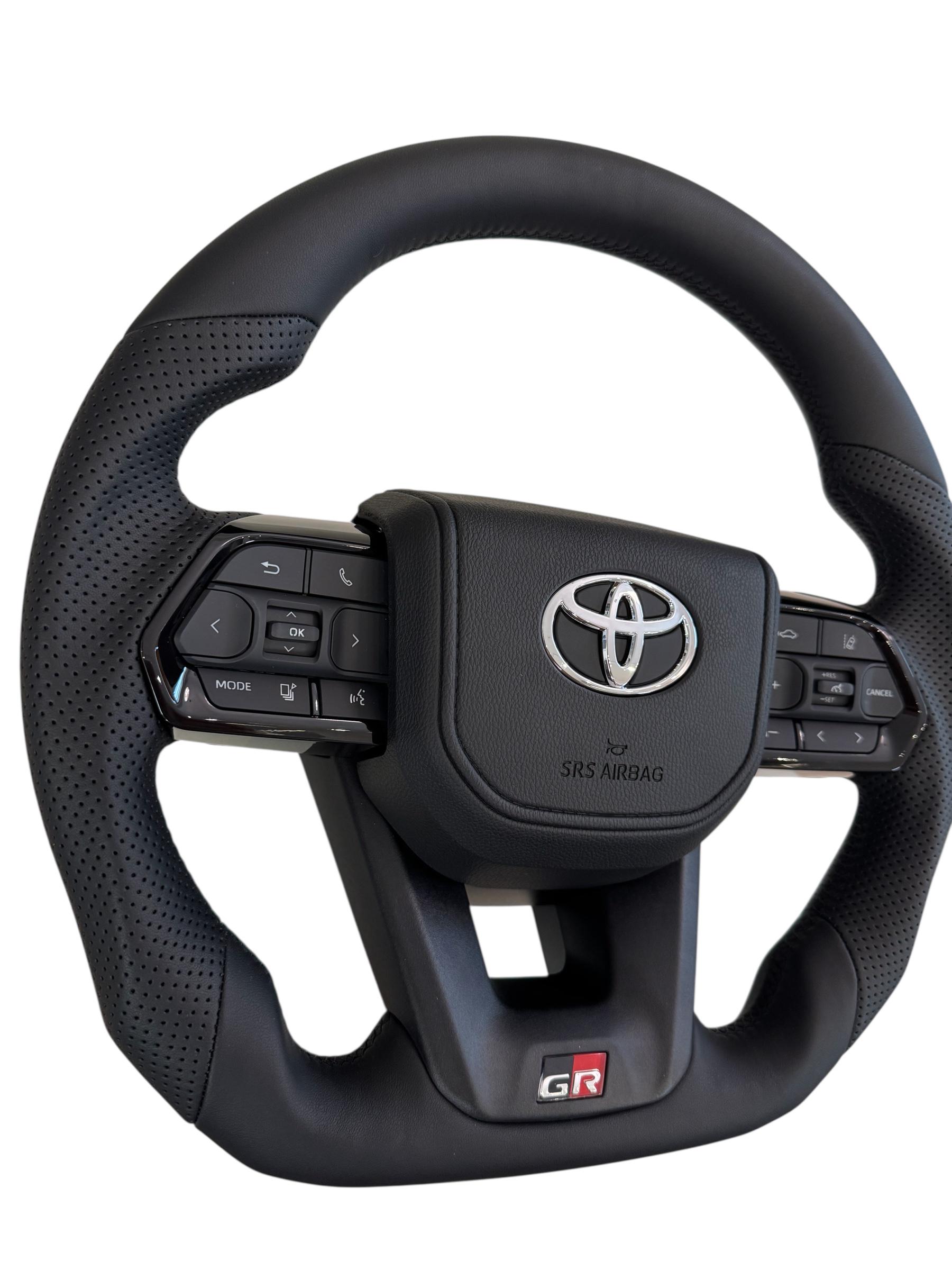 Руль для Toyota Land Cruiser 100 Prado 120 GR кожа со скошенным низом логотип хром (29342665) - фото 4 Руль для Toyota Land Cruiser 100 Prado 120 GR кожа со скошенным низом логотип хром (29342665) - фото 4