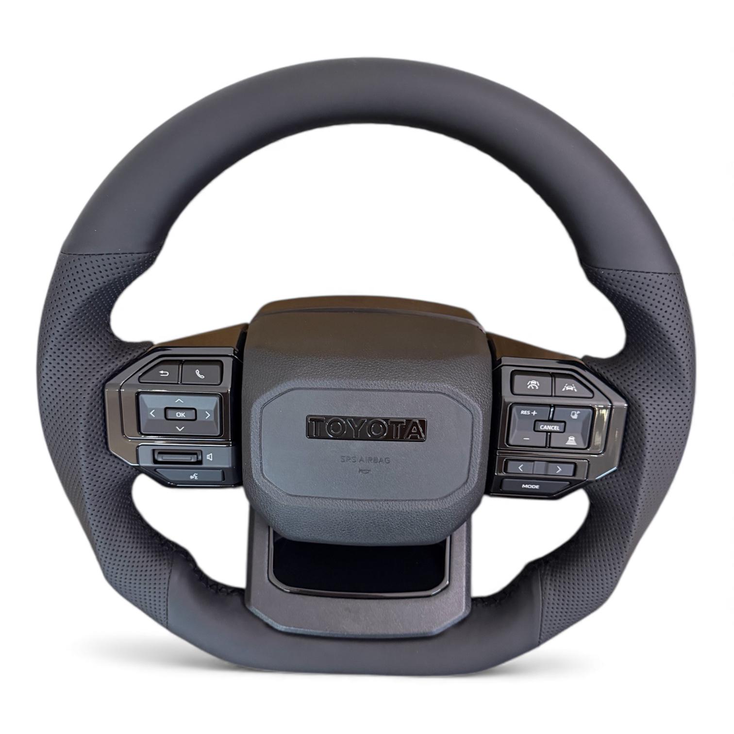 Руль для Toyota Land Cruiser 200/Prado 150 в сборе в стиле LC250 кожа со скошенным низом логотип черный глянец (29619930) - фото 4 Руль для Toyota Land Cruiser 200/Prado 150 в сборе в стиле LC250 кожа со скошенным низом логотип черный глянец (29619930) - фото 4