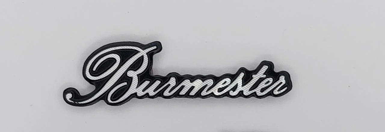 Эмблема Burmester на сетку динамика 2,9х0,9 см (1693669604)
