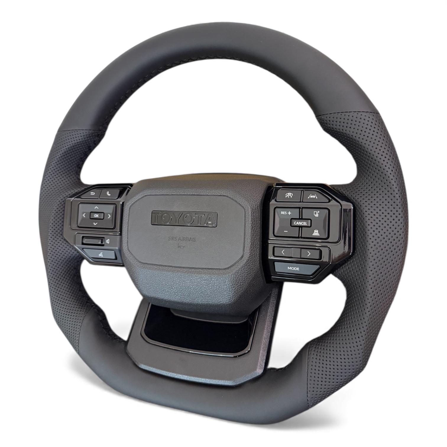 Руль для Toyota Land Cruiser 200/Prado 150 в сборе в стиле LC250 кожа со скошенным низом логотип черный глянец (29619930) - фото 5 Руль для Toyota Land Cruiser 200/Prado 150 в сборе в стиле LC250 кожа со скошенным низом логотип черный глянец (29619930) - фото 5