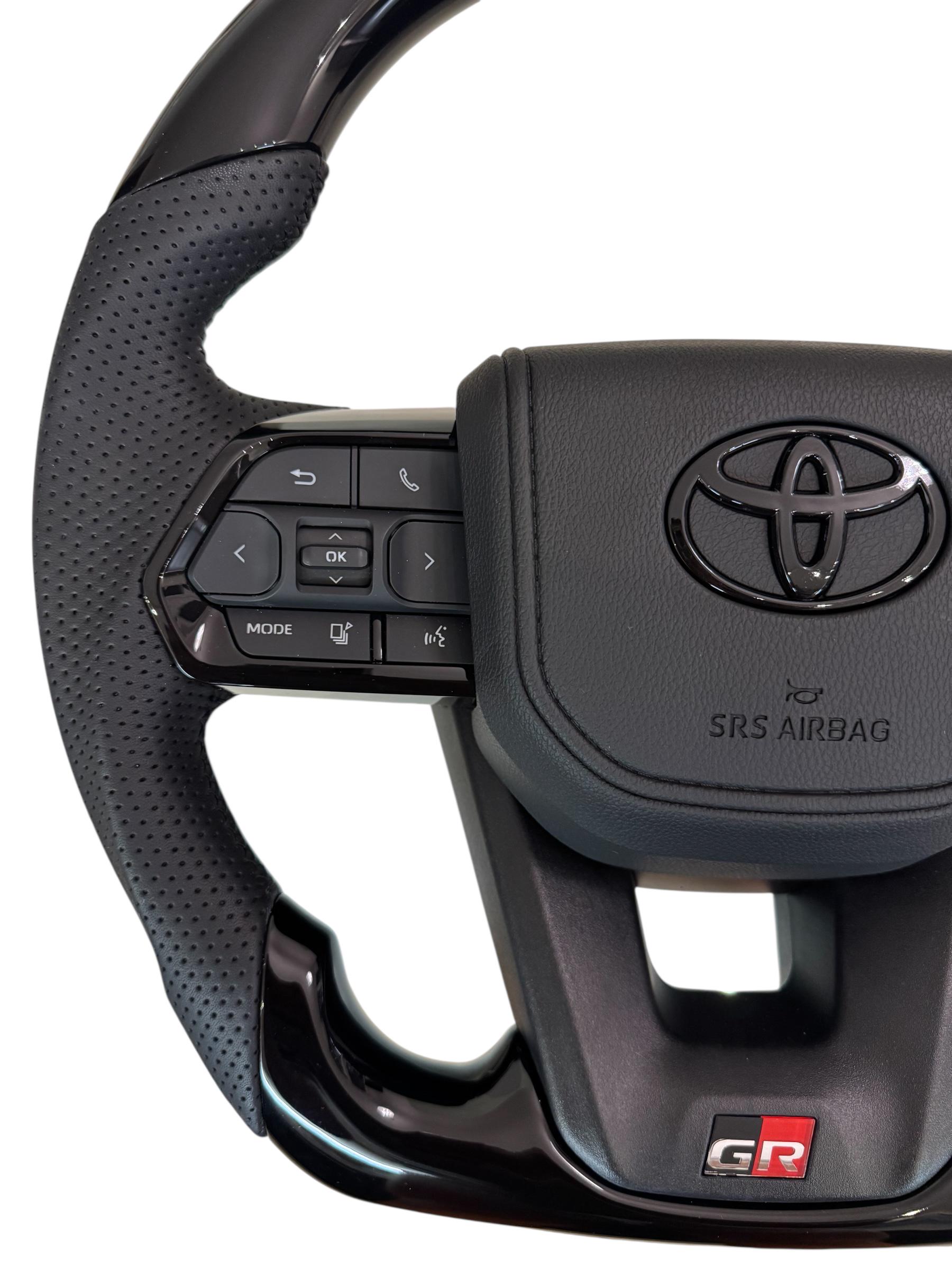 Руль для Toyota Tundra GR в сборе рояльный лак со скошенным низом логотип черный глянец (29390048) - фото 2 Руль для Toyota Tundra GR в сборе рояльный лак со скошенным низом логотип черный глянец (29390048) - фото 2