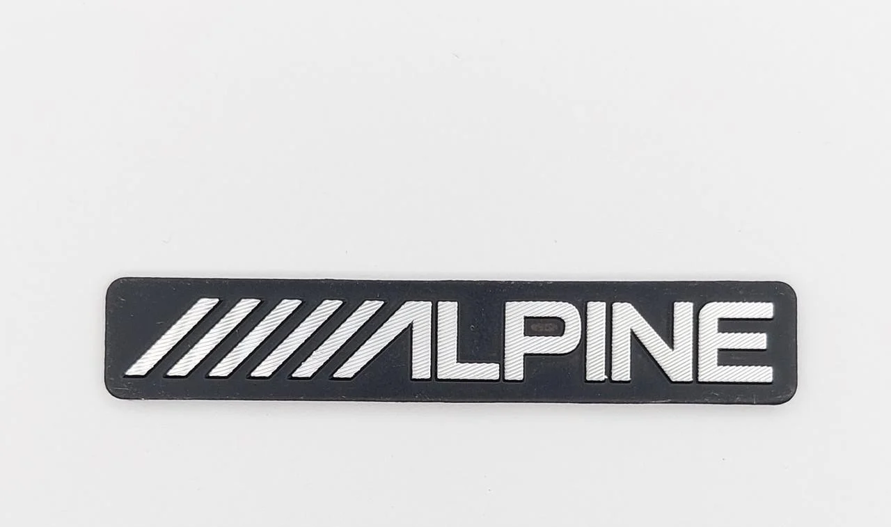 Эмблема Alpine на сетку динамика 5,4х0,9 см (1670547404)