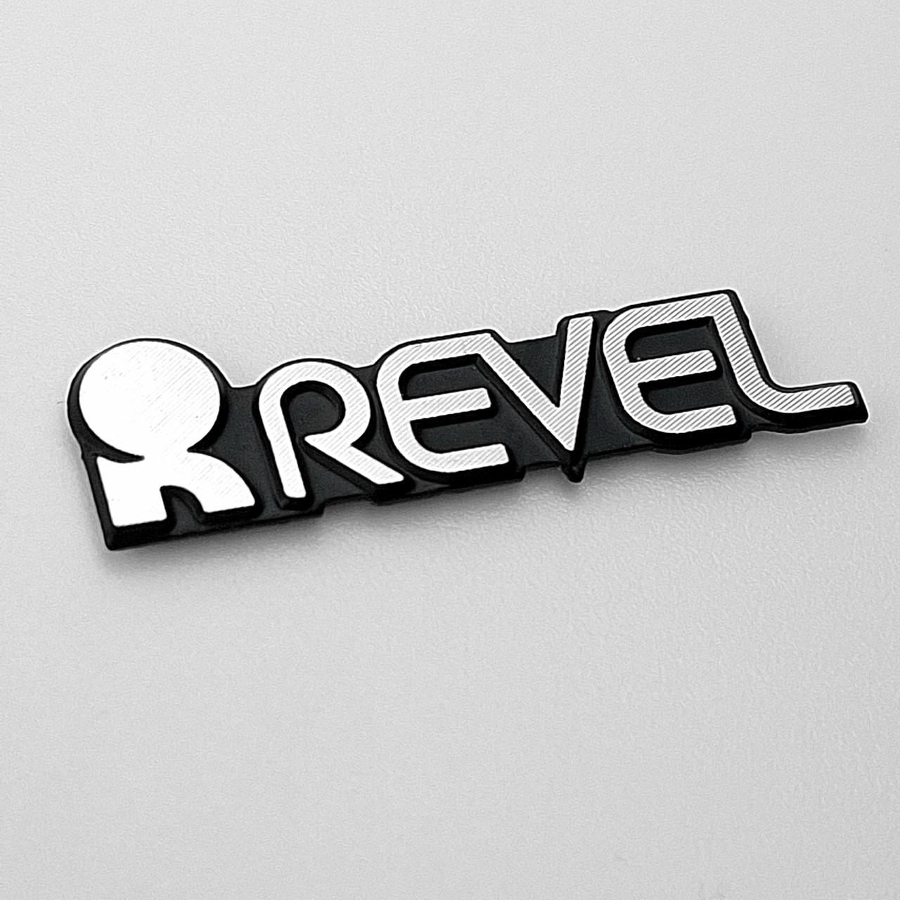 Эмблема Revel на сетку динамика 3х0,9 см (2795718364)