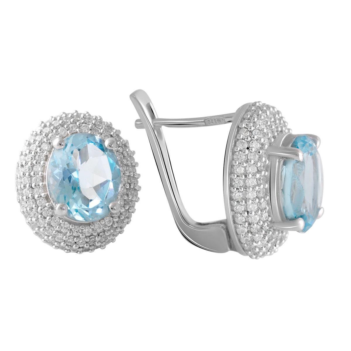 Сережки срібні з овальним натуральним топазом у круглій формі з розсипом каміння Сережки срібні з овальним натуральним топазом у круглій формі з розсипом каміння