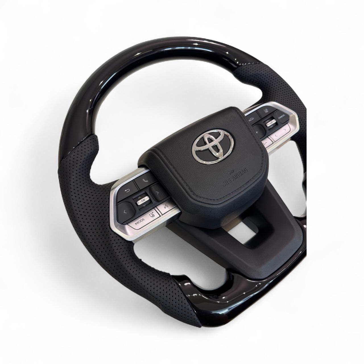 Руль для Toyota Land Cruiser 100/Prado 120 рояльный лак со скошенным низом логотип и кнопки хром (29014242) - фото 3 Руль для Toyota Land Cruiser 100/Prado 120 рояльный лак со скошенным низом логотип и кнопки хром (29014242) - фото 3