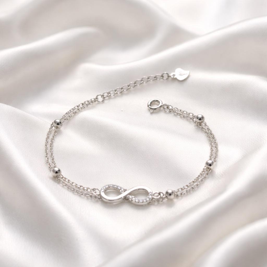 Браслет срібний з символом нескінченності білими фіанітами та декоративними кульками р. 17-20 см