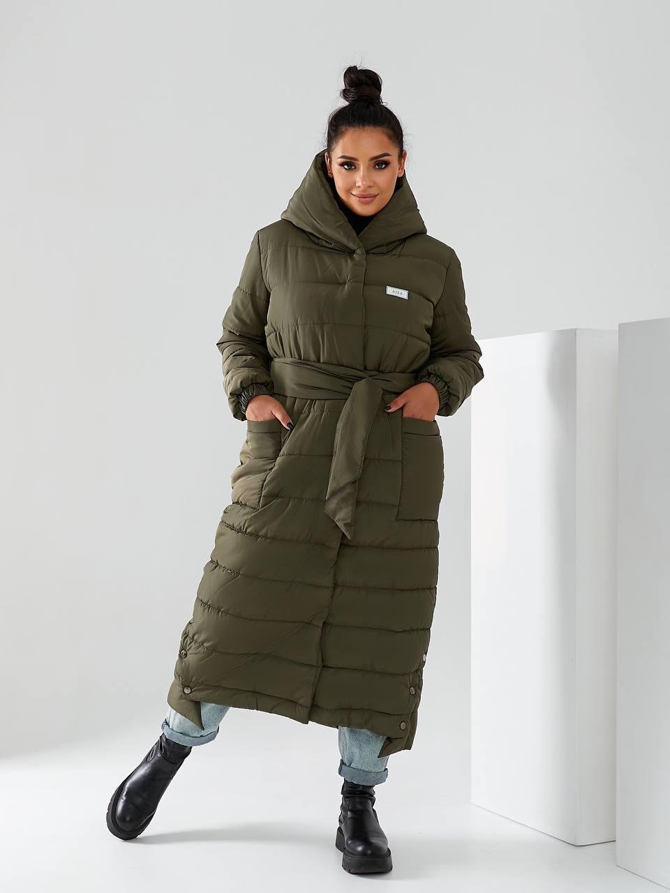 Пуховик длинный Aiza А032 на поясе кнопках молнии и с капюшоном р. 46-48 Хаки Пуховик длинный Aiza А032 на поясе кнопках молнии и с капюшоном р. 46-48 Хаки