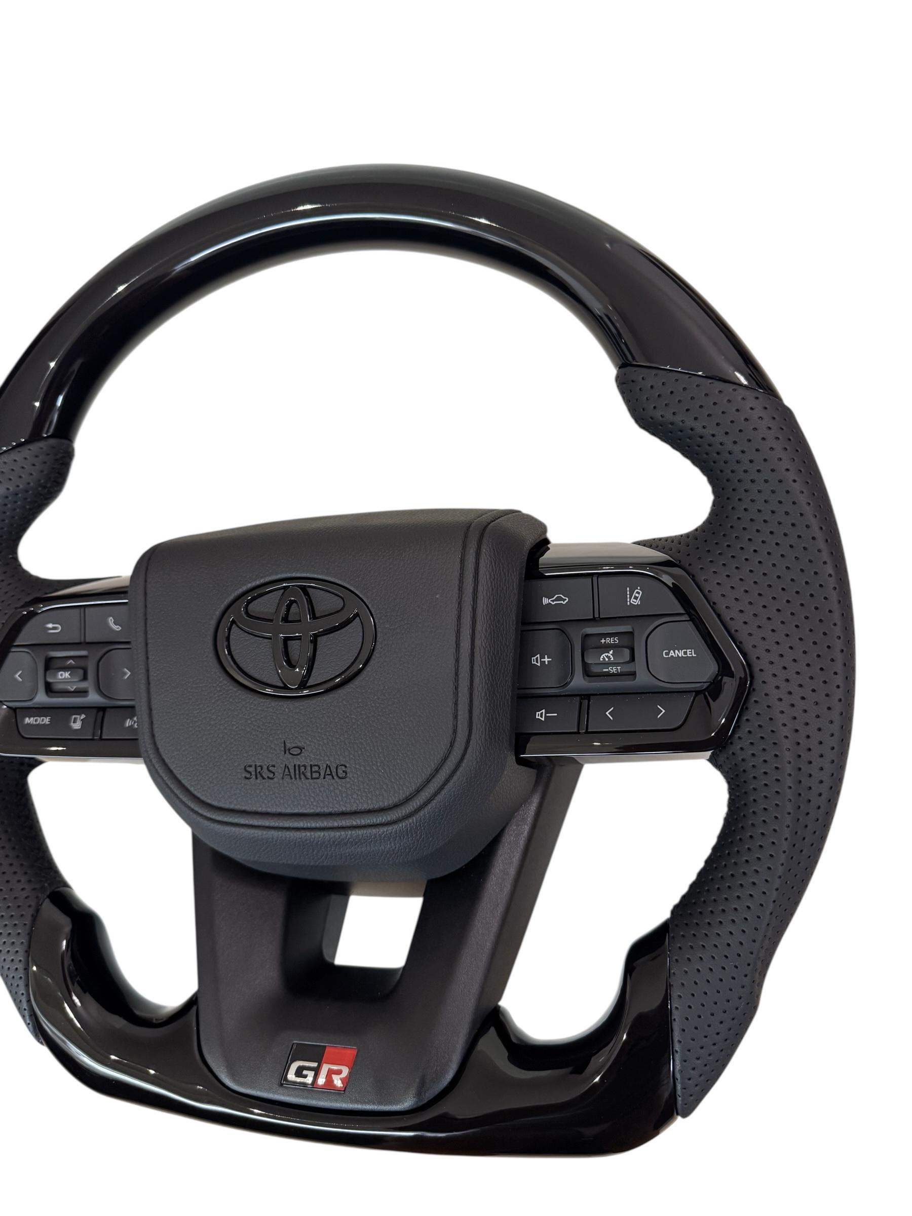 Руль для Toyota Tundra GR в сборе рояльный лак со скошенным низом логотип черный глянец (29390048) - фото 4 Руль для Toyota Tundra GR в сборе рояльный лак со скошенным низом логотип черный глянец (29390048) - фото 4