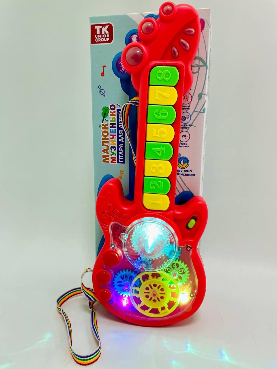 Гитара на батарейках TK Group 2 режима игры/8 песен/пианино/прозрачный корпус/подвижные шестерни Красный Гитара на батарейках TK Group 2 режима игры/8 песен/пианино/прозрачный корпус/подвижные шестерни Красный