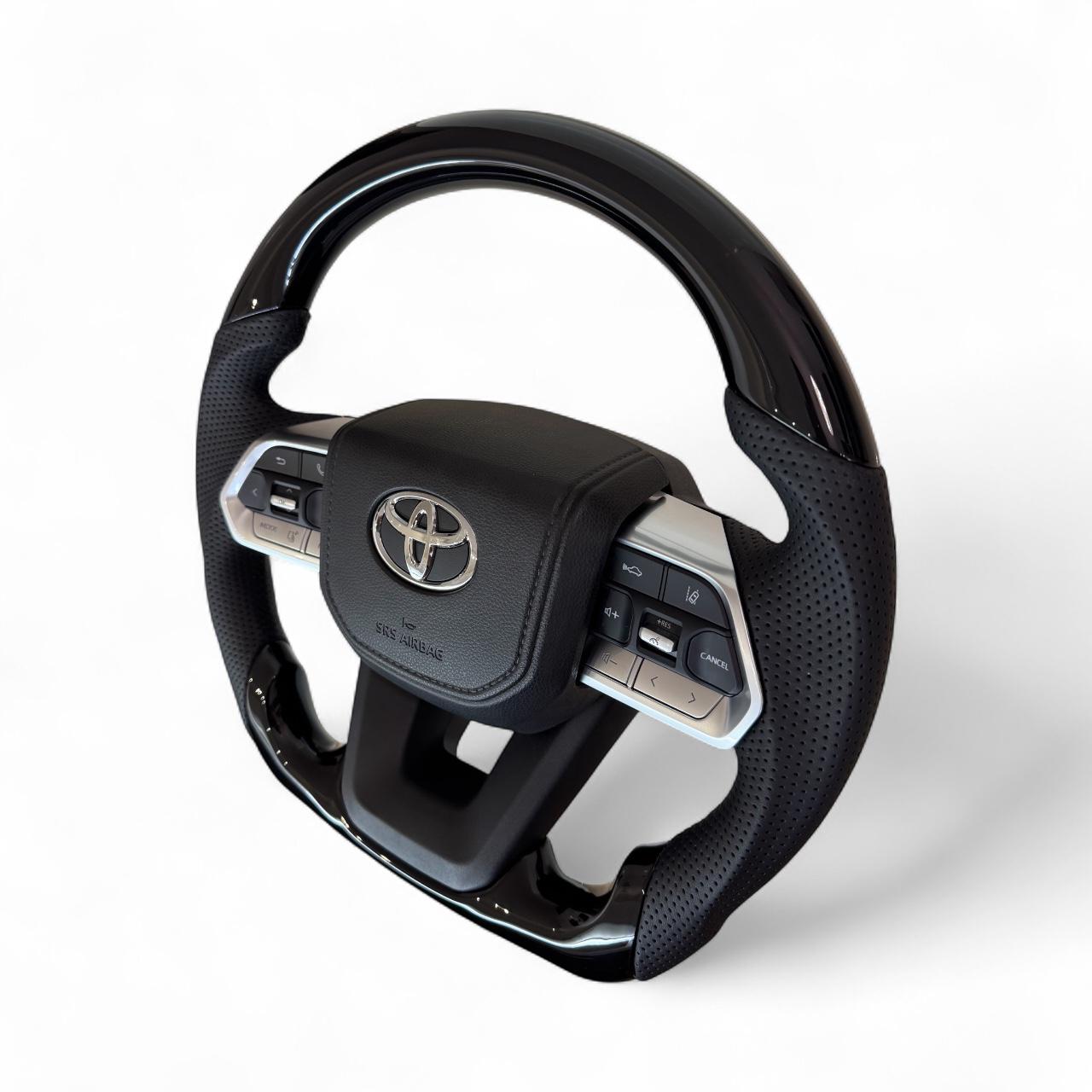 Руль для Toyota Land Cruiser 100/Prado 120 рояльный лак со скошенным низом логотип и кнопки хром (29014242) - фото 2 Руль для Toyota Land Cruiser 100/Prado 120 рояльный лак со скошенным низом логотип и кнопки хром (29014242) - фото 2