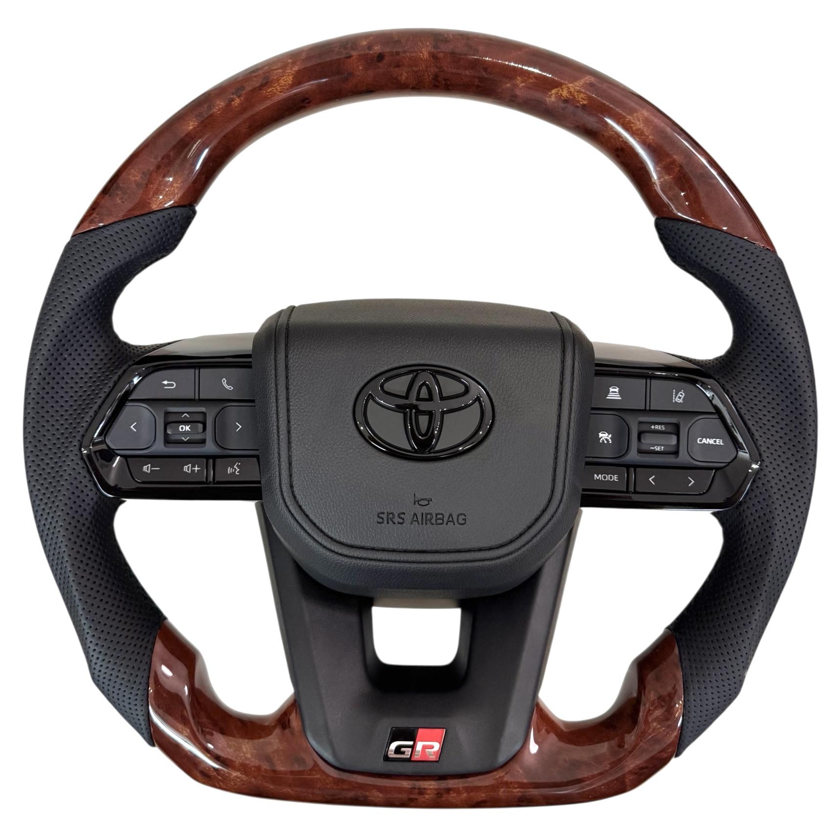 Кермо для Toyota Land Cruiser 100/Prado 120 GR під оригінальний колір салону в сборі зі скошеним низом логотип чорний глянець (30246663) Кермо для Toyota Land Cruiser 100/Prado 120 GR під оригінальний колір салону в сборі зі скошеним низом логотип чорний глянець (30246663)