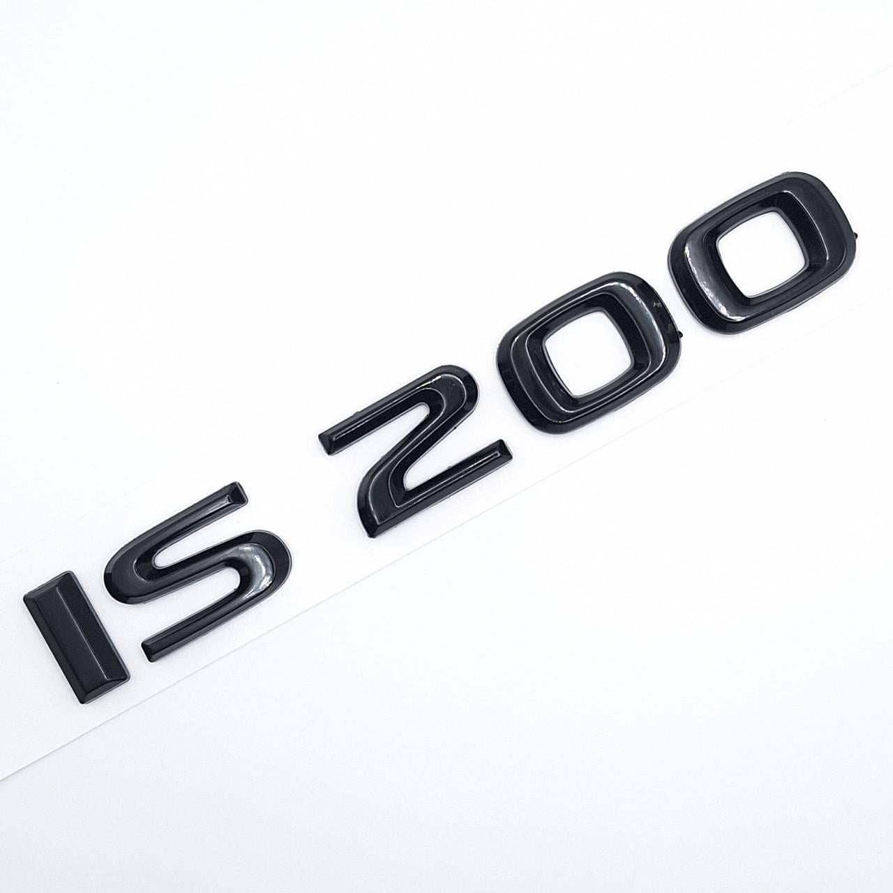 Эмблема надпись IS200 Lexus металл 15х2 см Черный глянцевый (2339587771)