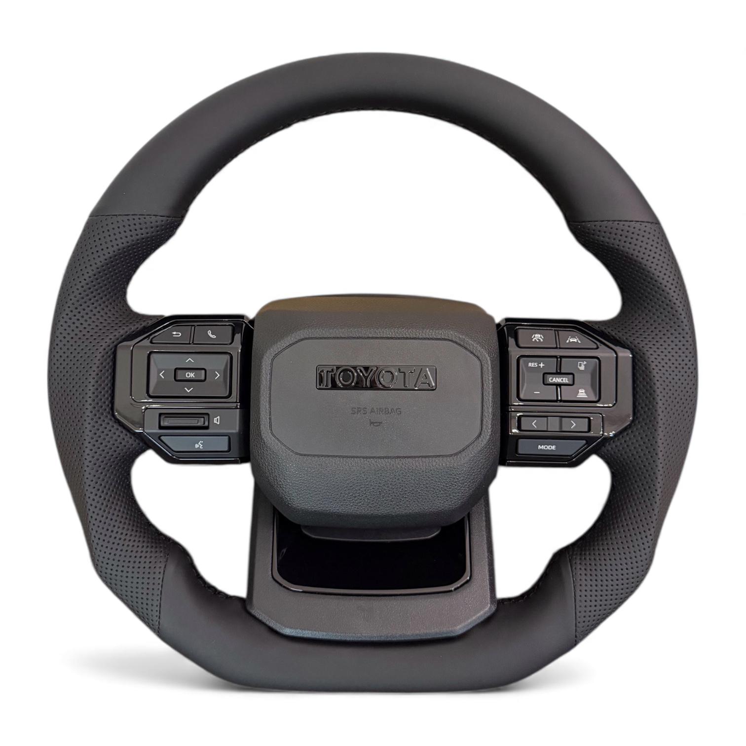 Руль для Toyota Land Cruiser 200/Prado 150 в сборе в стиле LC250 кожа со скошенным низом логотип черный глянец (29619930)